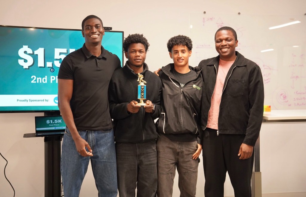 Pamimo and three teammates holding a second-place trophy in front of a $1.5K prize screen